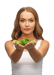 Image showing woman with spinach leaves on palms