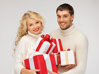 Image showing family couple in a sweaters with gift boxes