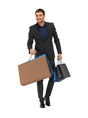 Image showing handsome man in suit with shopping bags