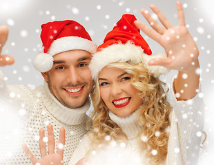 Image showing family couple in sweaters and santa's hats