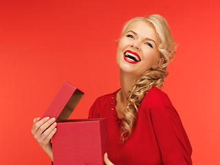 Image showing lovely woman in red dress with opened gift box