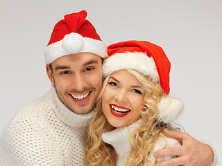 Image showing family couple in sweaters and santa's hats