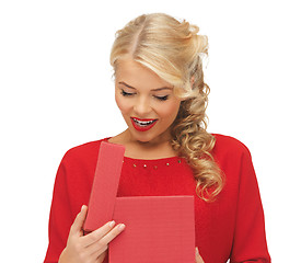 Image showing lovely woman in red dress with opened gift box