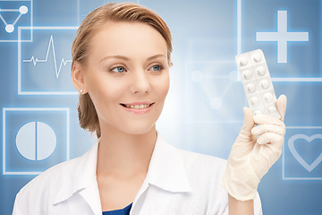 Image showing attractive female doctor with pills