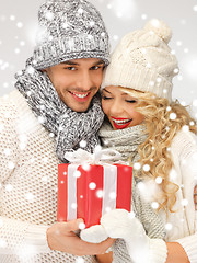 Image showing romantic couple in a sweaters with gift box