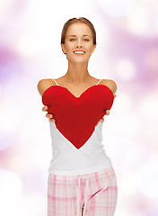 Image showing happy and smiling woman with heart-shaped pillow