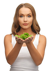 Image showing woman with spinach leaves on palms