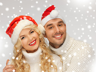 Image showing family couple in sweaters and santa's hats