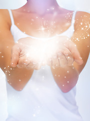 Image showing magic twinkles on female hands