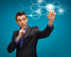 Image showing man in suit working with virtual screens