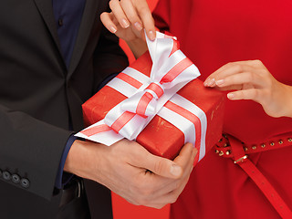 Image showing man and woman's hands with gift box