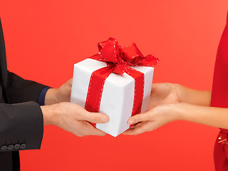 Image showing man and woman's hands with gift box