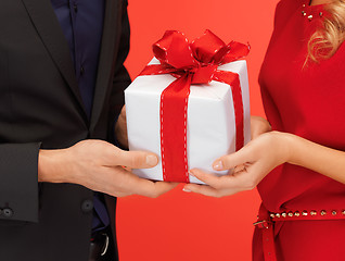 Image showing man and woman's hands with gift box