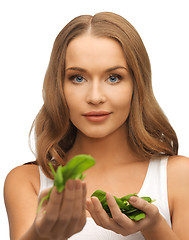 Image showing woman with spinach leaves on palms