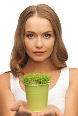 Image showing woman with green grass in pot