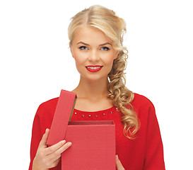 Image showing lovely woman in red dress with opened gift box