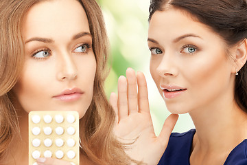 Image showing young beautiful women with pills