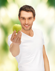 Image showing man in white shirt with green apple