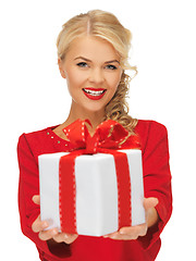 Image showing lovely woman in red dress with present