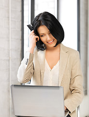 Image showing happy woman with laptop computer and credit card