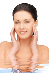 Image showing face and hands of beautiful woman in water