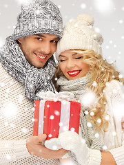 Image showing romantic couple in a sweaters with gift box