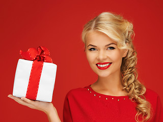 Image showing lovely woman in red dress with present