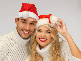 Image showing family couple in sweaters and santa's hats