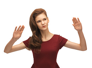 Image showing girl in red dress working with something imaginary