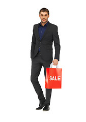 Image showing handsome man in suit with shopping bags