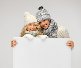 Image showing couple in a winter clothes holding blank board