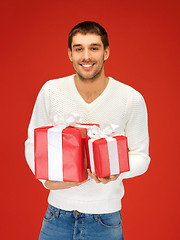 Image showing man holding many gift boxes