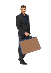 Image showing handsome man in suit with shopping bags