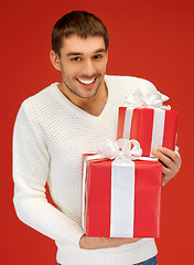 Image showing man holding many gift boxes