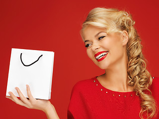 Image showing lovely woman in red dress with shopping bag