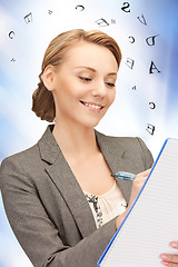 Image showing happy woman with big notepad