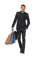 Image showing handsome man in suit with shopping bags