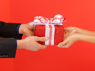 Image showing man and woman's hands with gift box