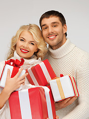 Image showing family couple in a sweaters with gift boxes