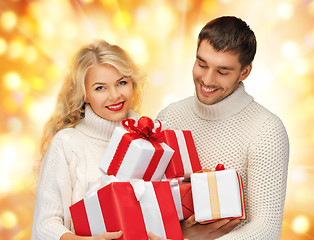 Image showing family couple in a sweaters with gift boxes