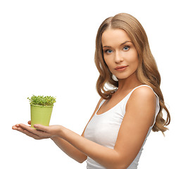 Image showing woman with green grass in pot