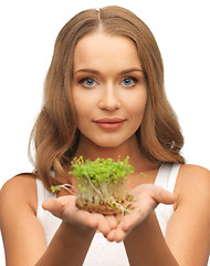 Image showing woman with green grass on palms