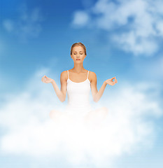 Image showing woman in undrewear practicing yoga lotus pose