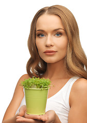 Image showing woman with green grass in pot