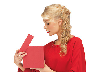 Image showing lovely woman in red dress with opened gift box