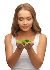 Image showing woman with spinach leaves on palms