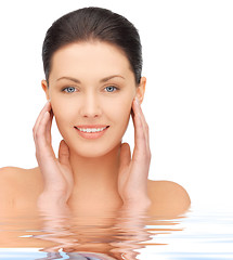 Image showing face and hands of beautiful woman in water