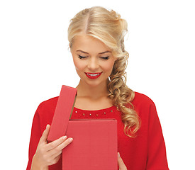 Image showing lovely woman in red dress with opened gift box