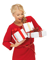 Image showing lovely woman in red dress with gift boxes