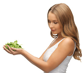 Image showing woman with spinach leaves on palms